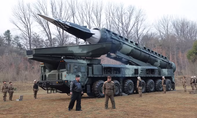 Lãnh đạo Kim Jong-un (áo đen) trong cuộc thử nghiệm vũ khí siêu vượt âm mới của quân đội Triều Tiên ngày 2/4. Ảnh: KCNA