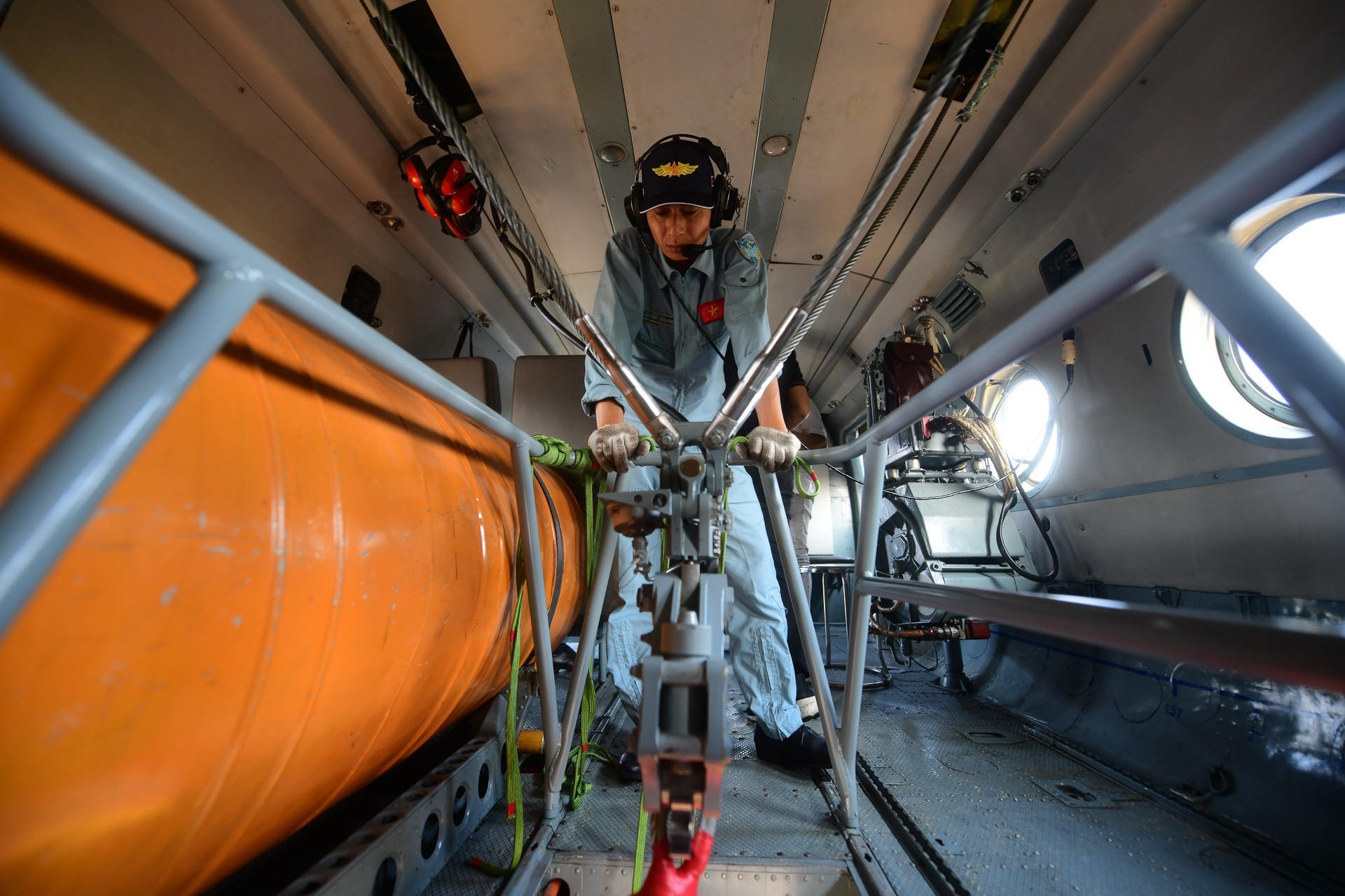 Một nhân viên cơ giới trên trực thăng phụ trách theo dõi cờ Tổ quốc. Lá cờ có diện tích 19m2 với quả đối trọng nặng 120kg.