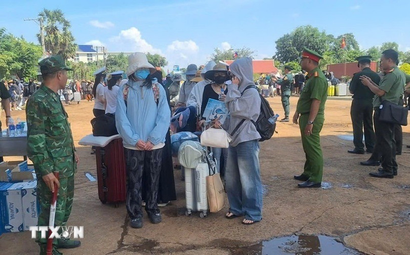 Lực lượng chức năng Việt Nam-Campuchia làm thủ tục bàn giao, tiếp nhận 353 công dân Việt Nam tại Cửa khẩu quốc tế Xa Mát, xã Tân Lập, tỉnh Tây Ninh. (Ảnh: TTXVN phát). ttxvn-tay-ninh-hoan-tat-thu-tuc.jpg