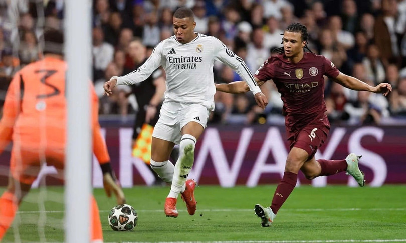 Kylian Mbappe rê bóng trước Nathan Ake trong trận Real gặp Man City ở lượt về vòng play-off Champions League trên sân Bernabeu, thành phố Madrid, Tây Ban Nha tối 19/2/2025. Ảnh: AFP 67464263-13f6-4567-8142-0e856a05bd45.jpg