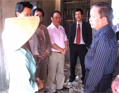 Bộ trưởng Nguyễn Hồng Quân (phải) thăm hỏi người dân vừa chuyển về Khu tái định cư Kỳ Liên, Kỳ Anh.