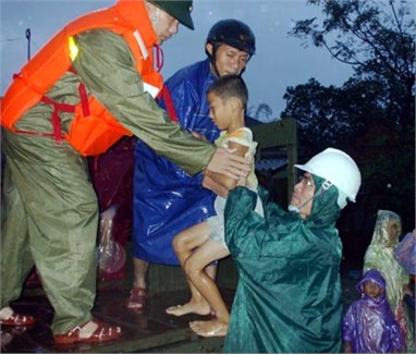 Phó Chủ tịch Thường trực UBND tỉnh Trần Minh Kỳ đưa trẻ em ở xã Cẩm Duệ (Cẩm Xuyên) di dời