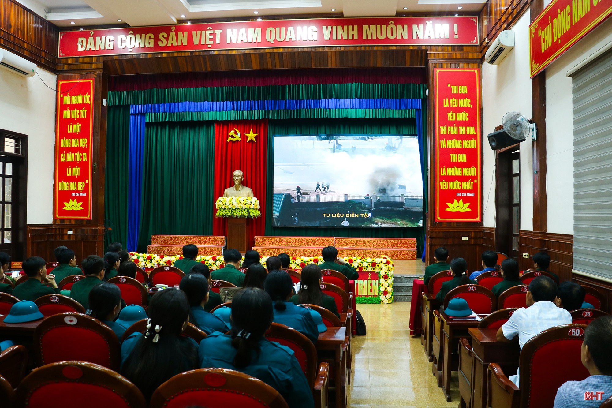 Đại biểu theo dõi video về việc nhận lệnh và thực hiện các bước chuyển lực lượng vũ trang từ trạng thái sẵn sàng chiến đấu lên trạng thái sẵn sàng chiến đấu cao.