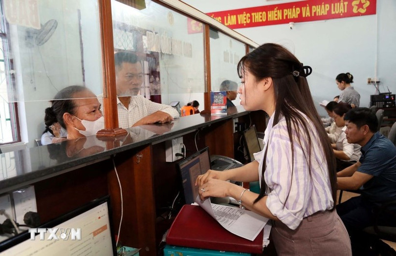 Cán bộ Trung tâm phục vụ hành chính công xã Hoàn Lão (tỉnh Quảng Trị) giải đáp các thắc mắc cho người dân trong giải quyết thủ tục hành chính. (Ảnh: Tá Chuyên/TTXVN) quang-tri-chinh-quyen-2-cap-di-vao-hoat-dong-doi-moi-vi-dan-phuc-vu-0107-2.jpg