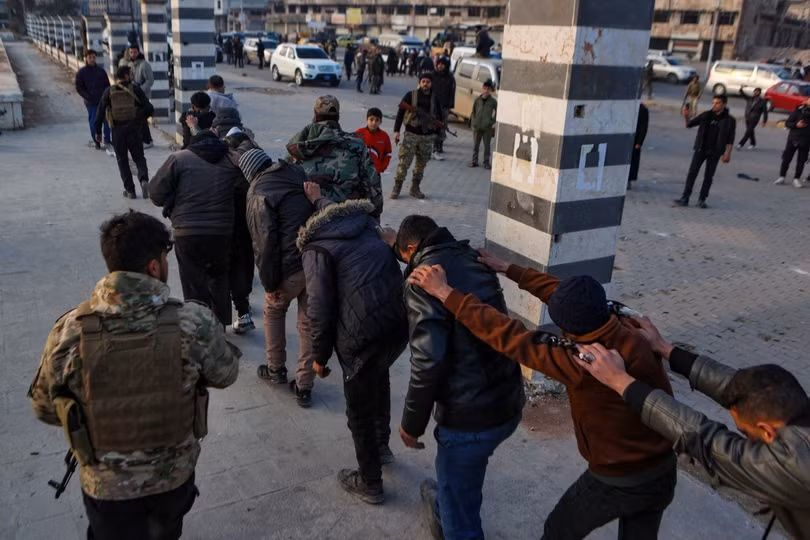 Binh sĩ quân đội chính phủ mặc thường phục bị dẫn giải tại thành phố Homs.