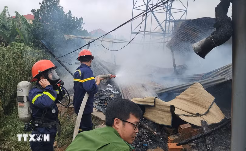 Lực lượng cảnh sát triển khai công tác chữa cháy tại hiện trường. (Ảnh: Nguyễn Dũng/TTXVN)
