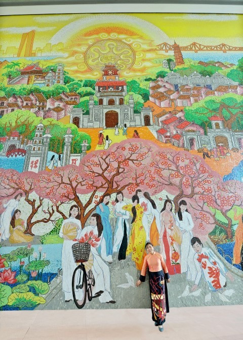 Họa sĩ Nguyễn Thu Thủy bên bức tranh gốm kỷ lục tại Lotte