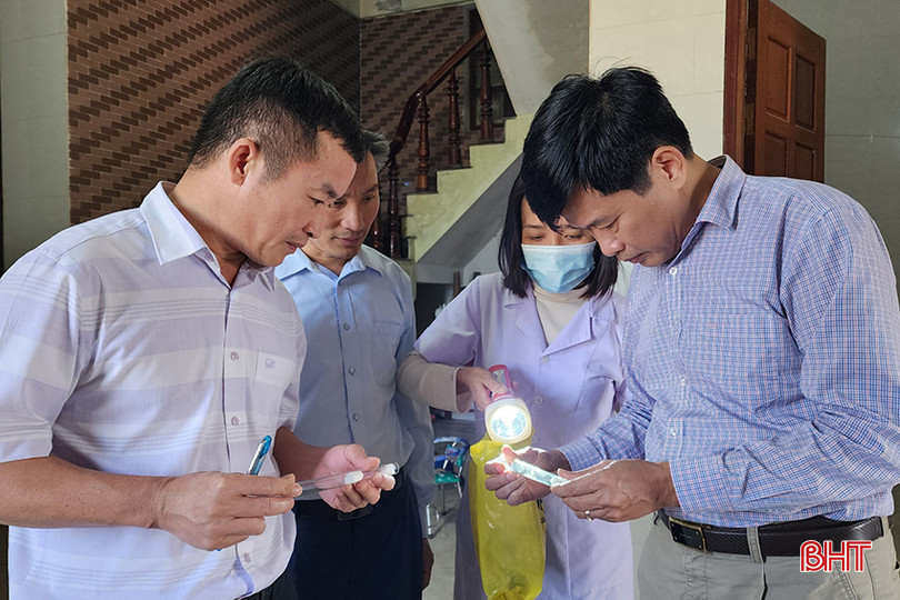 Bác sỹ Nguyễn Hữu Thanh - Phó Giám đốc CDC Hà Tĩnh (ngoài cùng bên trái) cùng cán bộ Trung tâm Y tế thị xã Kỳ Anh tiến hành định loại muỗi bắt được tại một hộ dân ở TDP Châu Phố. Ảnh 2.jpg