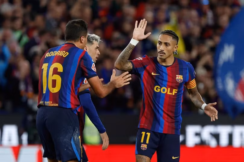Raphinha (phải) ăn mừng cùng Rodrigo sau khi cầu thủ này ghi bàn mở tỷ số cho Barca trong trận gặp Real Madrid tại La Liga trên sân Camp Nou, Barcelona, Tây Ban Nha, ngày 25/10/2026. Ảnh: AP