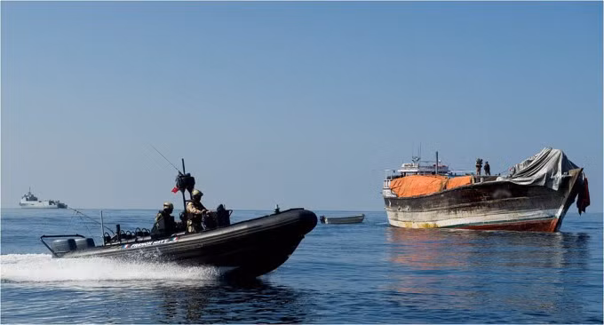Lực lượng Hải quân Liên minh châu Âu (EU NAVFOR) dùng xuồng cao tốc áp sát chiếc thuyền cũ (bên phải), nghi ngờ bị cướp biển Somalia sử dụng làm tàu mẹ hồi tháng 1/2014. Ảnh: AFP